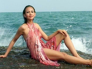 Erotic XXX scene of a busty brunette teasing her tits and pussy in the water